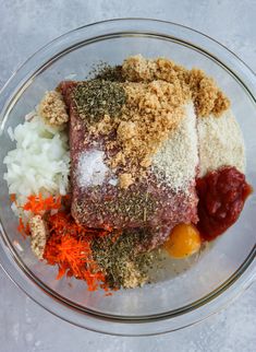 a glass bowl filled with meat and spices