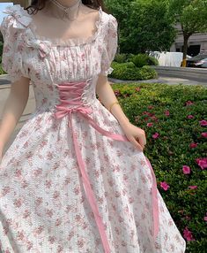 Lightweight and flowy sweet floral midi dress with short puff sleeves, frilly square neckline, little bows and a lace up corset waist. Concealed back zipper. Now available in a bright blossom pink and muted blush pink. S: 30"-32" chest, 26"-28" waist, 40" lengthM: 31.5"-33.5" chest, 27.5"-29.5" waist, 40" lengthL: 33"-35" chest, 29"-31" waist, 40" lengthXL: 34.5"-36.5" chest, 30.5"-32" waist, 40' length Short Sleeve Summer Dress With Lace-up Back, Summer Short Sleeve Dress With Lace-up Back, Summer Dresses With Lace-up Back And Short Sleeves, Fairycore Outfit, Floral Dress White, Corset Waist, Lace Up Corset, Pink Blossom, Spring Fling