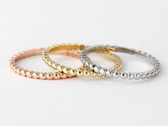 This is a women's 3 tone trio stackable ring set made of solid 10k yellow gold. This set comes with three 1.6mm beaded bands in white, yellow and rose gold. Great stacking set for everyday wear!  D E T A I L S : * Made of Solid 10k gold * Three tone gold  * Width: 1.6mm ( each band) * Processing time: 3-5 business days Check out our ring collection! https://www.etsy.com/ca/shop/DjaziaJewelry?ref=simple-shop-header-name&listing_id=1036212699&section_id=24093980 Trio Things, Stackable Ring Sets, Beaded Wedding, Ring Collection, Stackable Ring, Ring Band, Ring Collections, Stackable Rings, 10k Gold