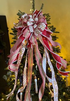 a christmas tree decorated with ribbons and lights