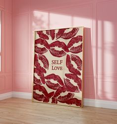 a red and white poster with the words self love printed on it in front of a pink wall