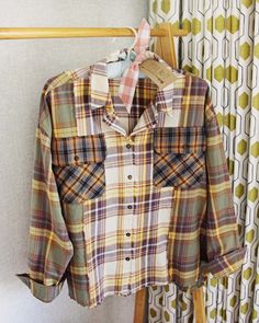 a plaid shirt hanging on a clothes rack