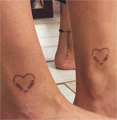 two people with tattoos on their legs that say i love you and they are holding hands