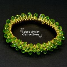 Italian made Green Peridot bead 18k yellow gold bracelet! Many 18k gold balls are scattered throughout the bracelet in between the peridot beads. A small white gold clasp completes the bracelet. There is one small 3 pointer diamond on the clasp.Total Weight: 54 gramsBracelet length: 7 inchesPrecious Metal: 18k yellow goldPrecious stones:-Peridot Teardrops 9mmx5.2mm-White Round Diamonds: 0.03 carat, QTY 1 (on the clasp)Hallmark: 750 Elegant Green Bracelet With Faceted Beads, Elegant Green Bracelets With Faceted Beads, Elegant Green Faceted Bead Bracelet, Elegant Lime Green Faceted Jewelry, Green Faceted Bead Bangle Jewelry, Elegant Green Bracelet With Spacer Beads, Green Faceted Beads Bangle, Elegant Green Bracelets With Spacer Beads, Elegant Peridot Round Beads Jewelry