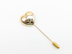 "A darling gold tone heart stick pin. Excellent condition with very little sign of wear.   Measures 2.75\" long, .75\" wide US SHIPPING: US orders over $35 ship free via first class mail. Orders over $200 receive a free priority mail upgrade. Expedited shipping is available. SHIPPING OUTSIDE THE US:  We combine shipping on multiple item orders.  Expedited shipping and insurance are available for an additional fee. GIFTS:  Request complimentary gift messages & gift boxes during the checkout proce Heart-shaped Gold Pins For Gifts, Valentine's Day Gold Brooch, Vintage Gold Heart Brooches, Vintage Heart-shaped Brass Necklace, Love Stick, Antique Heart-shaped Brooches As Gifts, Hollow Heart, Unique Packaging, Clover Charm