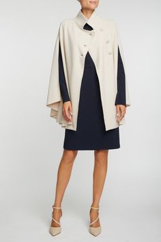 The Rachel Cape, a modern cape for women, is meticulously designed with flattering lines, tailored from durable fabric while maintaining a strong emphasis on comfort. This women's cape boasts the Mondrian Fabric, a classic soft microfiber, renowned for its travel-friendly nature and wrinkle-free quality, making it an ideal choice for the woman on the go. Featuring a double-breasted closure adorned with three fabric-covered buttons and elegant wings, this fashion cape exudes sophistication and co Wool Cape For Formal Occasions, Formal Wool Cape Outerwear, Elegant Office Cape Outerwear, Classic Cape Outerwear For Work, Elegant Cape-style Workwear Outerwear, Elegant Cape Outerwear For Work, Chic Cape Outerwear For Office, Chic Office Cape Outerwear, Modern Cape-style Workwear Outerwear