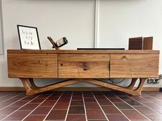 a wooden table sitting on top of a tiled floor