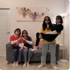 four women sitting on a couch in a living room