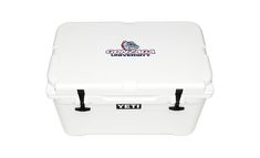 a white yeti cooler sitting on top of a white table next to a black handle