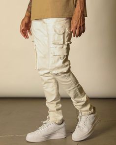 These jeans come in white. They are regular skinny jeans with cargo pockets on the sides of the legs. Made with high-quality denim, they are good pieces to add to your jean collection. White Utility Cargo Pants For Fall, Cream Utility Cargo Pants, Cream Utility Cargo Pants With Pockets, Utility Cream Cargo Pants With Pockets, Utility Cream Cargo Pants, White Cargo Pants With Hip Pockets For Streetwear, Cream Straight Leg Utility Cargo Pants, Fall Cream Cargo Pants With Pockets, White Straight Leg Casual Cargo Jeans