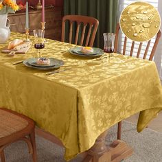 a dining room table with plates and glasses on it