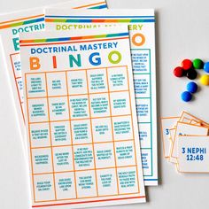 three printable game cards with candy on the table next to each other, including one for