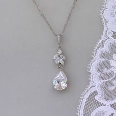 "Annie silver tone crystal bridal necklace has been designed by us to match our popular Annie earrings. A beautiful teardrop sits beneath a marquise crystal cluster all in white gold, for an elegant and classy bridal necklace. Length-16.5\" chain plus 1.5\" extender (optional) Crystal zircons set in a tarnish free rhodium base. (aka white gold) 💜 Available in rose gold, silver (rhodium) 💟 Items that coordinate or are frequently bought together (such as in photos/collages): Bracelets: https://w Dazzling White Gold Drop Necklace For Wedding, White Gold Cubic Zirconia Drop Necklace For Wedding, White Gold Diamond Cut Drop Necklace For Wedding, Sparkling Dangle Necklaces For Wedding, Sparkling Dangle Necklace For Wedding, Wedding Teardrop Pendant Necklace With Diamond Cut, Sterling Silver Drop Necklace For Wedding, White Gold Drop Bridal Necklace With Cubic Zirconia, White Gold Cubic Zirconia Drop Bridal Necklace