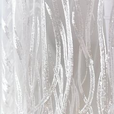 white sheer curtains with silver sequins on them