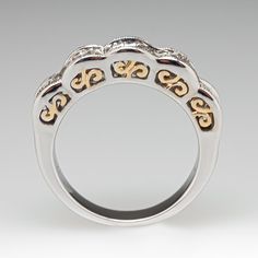 a white and yellow gold ring with two hearts on the middle, surrounded by diamonds