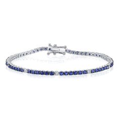 Over four carats of round blue sapphires are accented by eight white diamond stations in this unexpected combination of hues. Sophisticated and elegant, this piece can be worn on it's own or pairs nicely with tennis bracelets of all colors. Timeless Blue Round Bracelets, Sapphire Tennis Bracelet With Round Diamonds, Sapphire Diamond Tennis Bracelet With Round Cut, Sapphire Diamond Tennis Bracelet With Round Shape, Sapphire Brilliant Cut Tennis Bracelet, Classic Sapphire Tennis Bracelet With Brilliant Cut, Classic Round Sapphire Diamond Bracelet, Timeless Blue Diamond Bracelet, Luxury Blue Diamond Bracelet