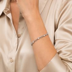 Simple and shimmering, this diamond bracelet is just Mom's style. Fashioned in sterling silver, this design features diamond composites - each centered with a diamond artfully set to enhance size and sparkle. The word "mom" is sculpted as print-font links to complete the alternating pattern. Captivating with 1/6 ct. t.w. of diamonds and a bright polished shine, this 7.5-inch bracelet secures with a tongue and groove clasp. Silver Brilliant Cut Diamond Bracelet In Platinum, Silver Platinum Diamond Bracelet With Brilliant Cut, Platinum Diamond Bracelet With Accents, Modern Diamond Tennis Bracelet For Formal Occasions, Silver Diamond Jubilee Bracelet In Platinum, Dazzling Diamond Bracelet With Diamond Accents, Silver Diamond Bracelet With Pavé Setting, Silver Platinum Diamond Bracelet For Anniversary, Elegant Diamond White Tennis Bracelet With Single Cut Diamonds