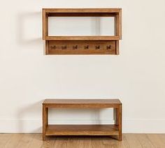 two wooden shelves on the wall with one shelf below them and another shelf below it