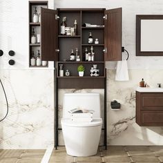 a white toilet sitting in a bathroom next to a sink