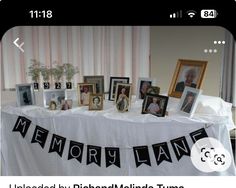 an image of a table with pictures on it and the words memory lane spelled in black