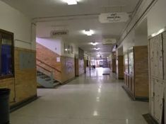 an empty hallway in a building with stairs