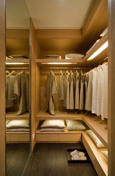 a walk in closet filled with lots of clothes