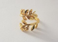 a gold ring with leaves on it