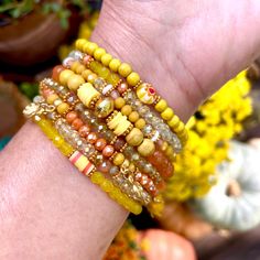 "Yellow stack bracelet set mixed in with beautiful light orange agate and crystal beads.Adorable charms and Nepal influenced beads.  The yellows and oranges shimmer and glisten. Feels warm, sunny and zen.  Each bracelet has an intricate mix of beads and spacers. Eclectic vibe perfect for any season or occasion. *All sets and individual pieces, created with much love and great attention to detail, considering mix of color, texture, handmade charms, new and vintage beads. Attached to your set is my signature Live Laugh Love charm and tiny India Bells. These bells, with their delightful light sound, will always remind you of the true purpose of life. Live Well, Laugh Often, Love Much! Can be worn individually, as a set or mix in with your stacking bracelet collection. All bracelets measure ap Yellow Beaded Bracelets, Acrylic Nails Almond Shape, Autumn Bracelet, Red Beaded Bracelet, Stack Bracelet, Yellow Bracelet, Fancy Jewellery Designs, Orange Agate, Yellow Jewelry