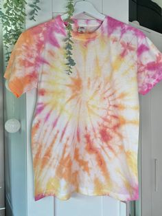 High Quality Handmade Adult and Children's Tie-dye T-shirt's - 100% Cotton! At Tie-dye by Rhi we have a wide variety of colours and sizes available, with each order being handmade to the highest quality. We can customise orders with multiple colours by clicking the 'Custom order' (£20.00) option and leaving your design requirements and size in the personalisation box. FREE standard delivery or upgrade to express delivery! With the quickest turn around possible we will get packaging your order as Pink Hand Dyed Cotton Top, Pink Bleached Short Sleeve T-shirt, Summer Crew Neck T-shirt With Natural Dye, Hand Dyed Yellow Tops For Summer, Hand Dyed Yellow Top For Summer, Yellow Hand-dyed Top For Summer, Summer Hand-dyed Yellow Top, Summer Yellow Hand-dyed Top, Casual Natural Dye T-shirt For Summer