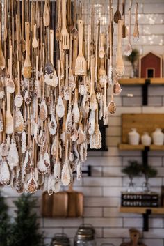 a bunch of spoons hanging from the ceiling