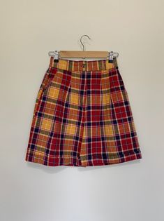 "Awesome high waisted 90's plaid shorts. High waisted fit, looser through the hips, and two front pockets. Button and zipper closure with elastic waistband in back. Classic 90's bright colored plaid pattern. Shorts are in excellent clean condition. Measurements are taken zipped or buttoned up and laid comfortably flat then x 2 for total circumference (inches) Tag Size 7/8 Waist 26\"~28\" Hips 45\" Length 19.5\" Inseam 7\" Rise 13.5\" Bottom leg Opening Circumference 25\" All items are free of ri 90s Inspired Fitted Short Bottoms, Retro Short Leg Bottoms With Pockets, Retro Bottoms With Pockets And Short Legs, Retro Bottoms With Pockets In Short Length, Retro Short Bottoms With Pockets, 90s Inspired High Waist Fitted Bottoms, 90s Inspired Fitted High Waist Bottoms, Retro High Rise Bottoms With Built-in Shorts, Retro High Waist Shorts With Belt Loops