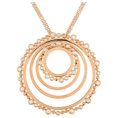 Bucherer combined beauty and elegance in this rose gold necklace with a diamond-dotted round pendant. The pendant features multiple rings arranged in an off-centered concentric patter. Two of the rings are detailed with bezel-set round diamonds in a bead-like style. The pendant hangs elegantly from a 28-inch-long necklace chain fastened by a lobster clasp.This brand new Bucherer 18K Rose Gold 0.89ct Diamond Circle Necklace comes with the manufacturer's box. Diamond Circle Necklace, Multiple Rings, Peridot Necklace, White Gold Set, Circle Diamond, White Gold Necklaces, Modern Necklaces, Teardrop Necklace, Diamond Drops