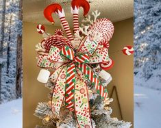 a christmas tree decorated with candy canes and snow