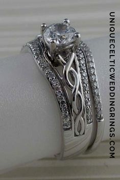 a close up view of a wedding ring with diamonds on it's side and the band