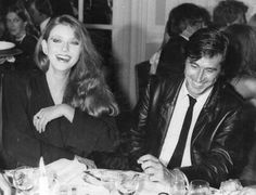 black and white photograph of two people sitting at a table