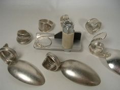 several silver objects sitting on top of a white table