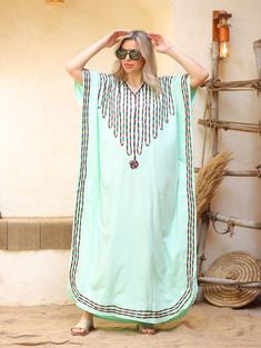 An elegant and stylish caftan will make you feel like African royalty. It's extremely elegant with a dash of colorful cotton embroidery adorning the kaftan. Ideal for plus size women as well. Made of extremely soft fabric to make you feel free and beautiful at the same time.  This Kaftan is ideal to wear for any casual occasion. Whether taking a trip down the shopping lane, or home-based kitty parties, or about anything else, wearing this dress will make you feel classy and comfortable. Fabric : Embroidered Green Kaftan, Green Embroidered Bohemian Kaftan, Green Embroidered Bohemian Style Abaya, Green Free Size Festival Kaftan, Bohemian Green Embroidered Abaya, Embroidered Green Bohemian Kaftan, Green Kaftan For Vacation And Eid, Green Embroidered V-neck Kaftan, Green Bohemian Embroidered Abaya