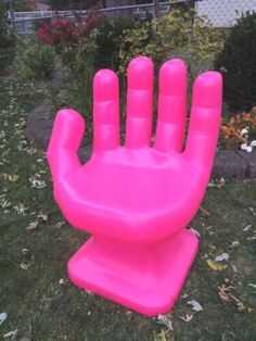 an inflatable hand sitting on top of a lawn