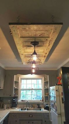 a kitchen with an old light fixture hanging from the ceiling