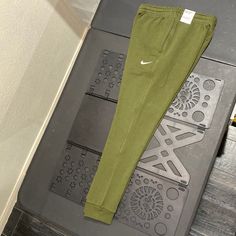 Nike Mens Sportswear Club Fleece Tapered Leg Jogger Olive Green Casual Green Moisture-wicking Sweatpants, Green Moisture-wicking Casual Sweatpants, Nike Sportswear Tracksuit For Sports, Green Sweatpants With Pockets For Sports, Moisture-wicking Cotton Sweatpants For Training, Cotton Moisture-wicking Sweatpants For Training, Nike Fleece Sweats For Sports, Casual Tracksuit With Side Pockets For Sports, Cotton Sports Sweats With Side Pockets