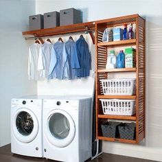 a washer and dryer sitting next to each other in front of a wooden shelf