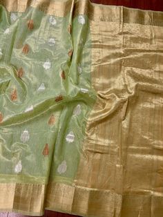 Beautiful Pista Green color Linen Soft Silk Saree with Weaved Buttas all over. Saree is super light weight and very Stable. Copper and Sliver Buttas on the body of the Saree while the Border and Pallu is Matt Gold. Please note - Since the material is tissue, it might looks lighter in shade in sunlight and darker in room-light specially in yellow light. Item : SareeColor : Pista GreenBase Fabric : Linen Soft Tissue Silk Blouse piece : YesBlouse material : Linen Soft Tissue Silk Transparent (Yes/N Green Tissue Silk Dupatta, Green Tissue Silk Dupatta For Transitional Season, Pista Green Cotton Silk Dupatta For Festivals, Pista Green Chanderi Traditional Wear For Festivals, Festival Chanderi Traditional Wear In Pista Green, Festive Pista Green Self Design Dupatta, Festive Pista Green Self-design Dupatta, Green Chanderi Sets With Zari Weaving, Festive Pista Green Traditional Wear With Self Design