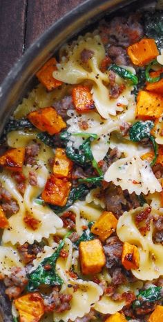 close-up of Creamy Butternut Squash Pasta with Sausage and Spinach in a stainless steel pan Squash Pasta