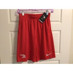 Elevate Your Child's Athletic Wardrobe With These New Nike Performance Shorts. The Solid Red Color With The Iconic Nike Logo Adds A Touch Of Style To Any Sports Outfit. The Drawstring Closure Provides A Secure And Comfortable Fit, While The Elastic Waist And Pockets Add Convenience. Made From A Blend Of Polyester And Blended Fabric, These Shorts Are Suitable For All Seasons, Whether It's Winter, Summer, Fall, Or Spring. Designed For Boys Who Love Sports, These Shorts Are Perfect For Any Occasion Nike Tech Shorts, Girls Nike Shorts, Sports Outfit, Nike Basketball Shorts, Nike Bottoms, Young Athletes, Nike Dri Fit Shorts, Red Nike, Nike Tech