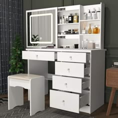 a white dressing table with drawers and stools next to a large mirror on the wall