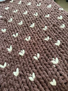 a crocheted blanket with white butterflies on it