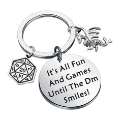 a metal keychain that says it's all fun and games until the dm smiles