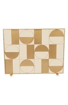 a white and gold box with circles on the front, in an abstract pattern that looks like it has been made out of cardboard