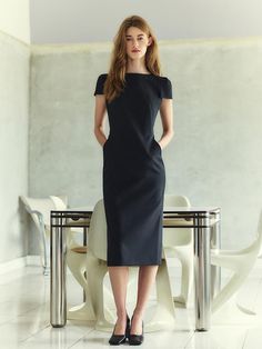 This sophisticated sheath dress features a sleek, form-fitting silhouette that extends to a midi length, providing an elegant and streamlined look. The dress is characterized by short, structured sleeves and a round neckline that add a touch of classic style. Its tailored fit highlights the natural curves of the body while maintaining a professional and polished appearance. The fabric is a dense, smooth textile, enhancing the dress's quality and ensuring it holds its shape throughout wear.- The structured sleeves and round neckline create a balanced and refined look, suitable for business or formal occasions.- Its solid black color adds to the versatility, making it easy to accessorize with a range of colors and styles.- The dress's midi length not only contributes to its elegance but also Classic H-line Midi Dress For Work, Black H-line Midi Dress For Formal Occasions, Fitted Midi Dress With Flattering Silhouette And Short Sleeves, Classic Sheath Midi Dress For Evening, Black H-line Midi Dress For Work, Classic Sheath Midi Evening Dress, Classic Knee-length Midi Dress With Flattering Silhouette, Sleek Structured Fitted Dress, Structured Midi Dress With Flattering Silhouette For Work