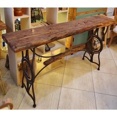 an old fashioned sewing machine sitting on top of a wooden table in a room filled with furniture